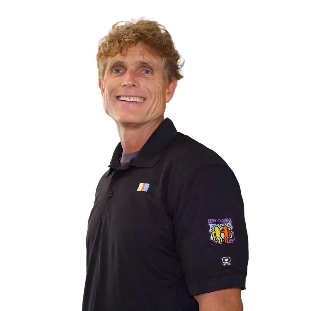 side view of man wearing polo with colorful best buddies logo on the arm sleeve
