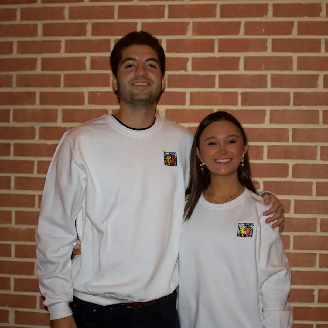 White crewneck sweatshirt with colorful Best Buddies Haring logo on the front