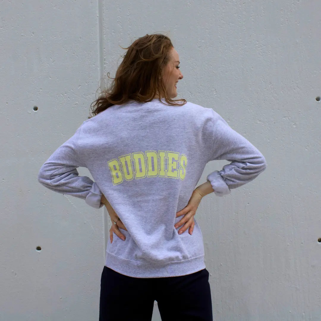 Grey crewneck sweatshirt with "Best" on the front and "Buddies" on the back in yellow lettering