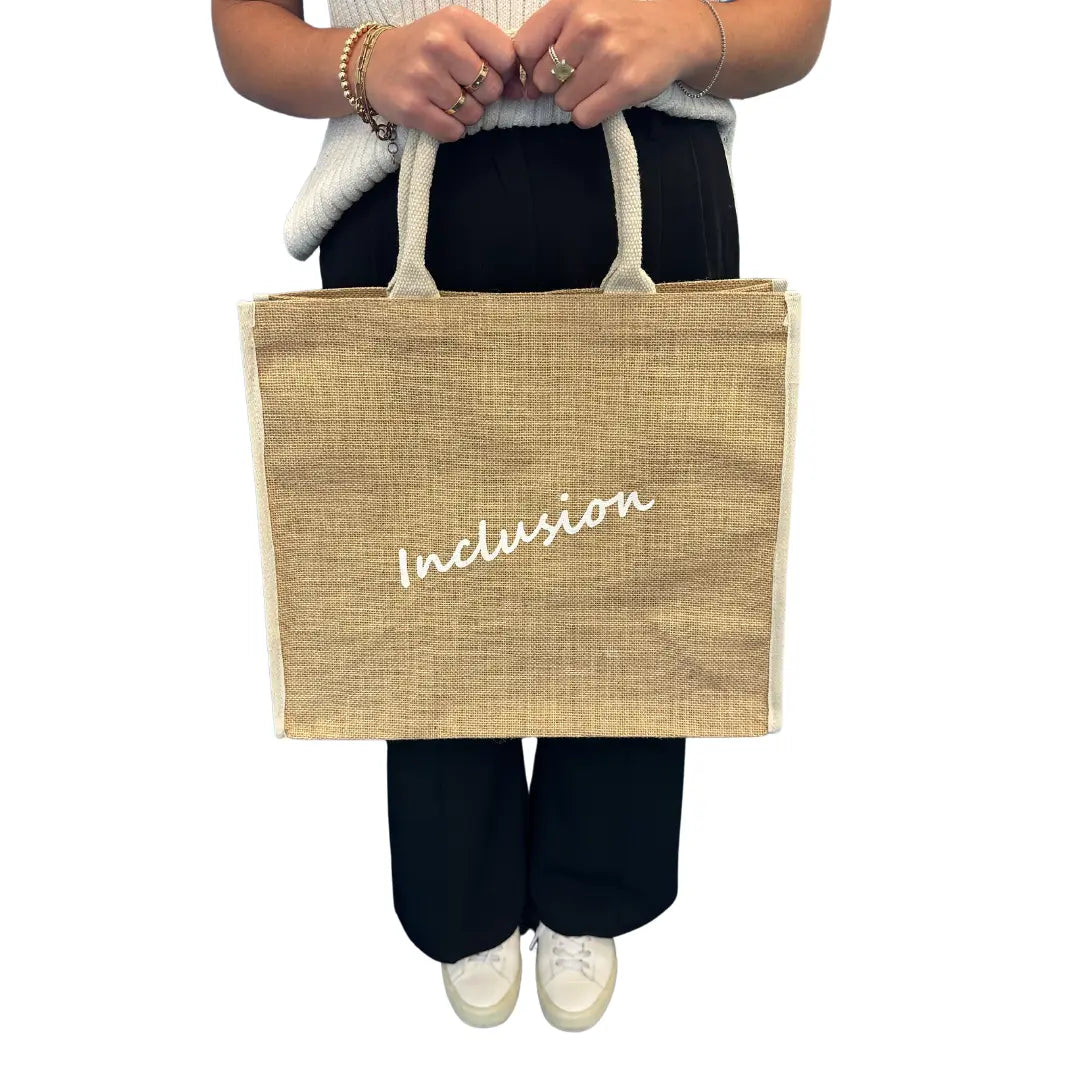 Jute tote bag with white haring Best Buddies logo on one side and "Inclusion" white letters on the other