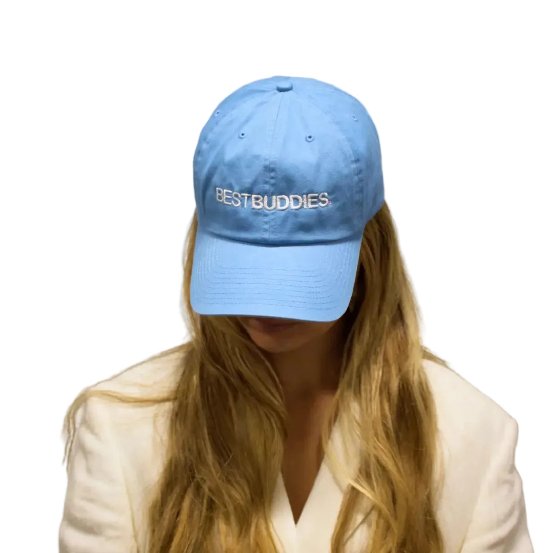 girl looking down wearing a carolina blue hat that says best buddies on front of hat