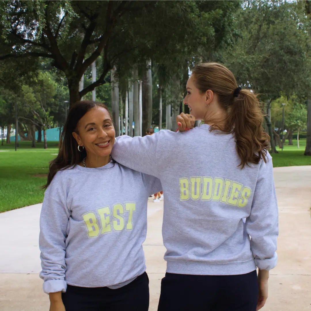 Grey crewneck sweatshirt with "Best" on the front and "Buddies" on the back in yellow lettering