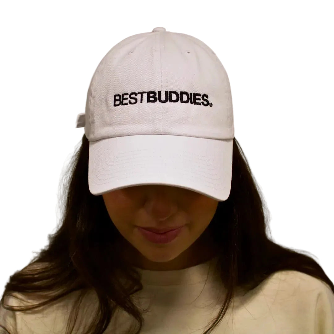 White cap with "Best Buddies" printed on the crown in black letters