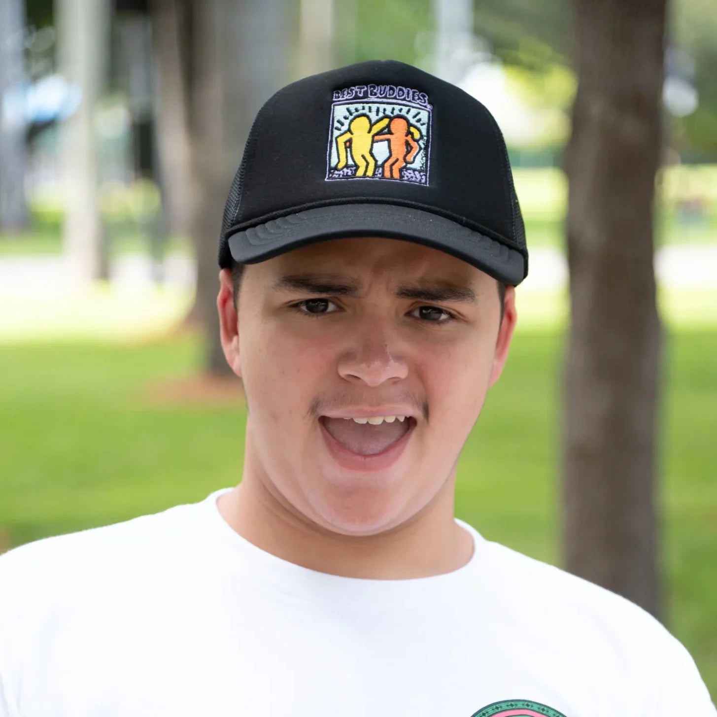 Black trucker hat with colorful traditional haring Best Buddies logo