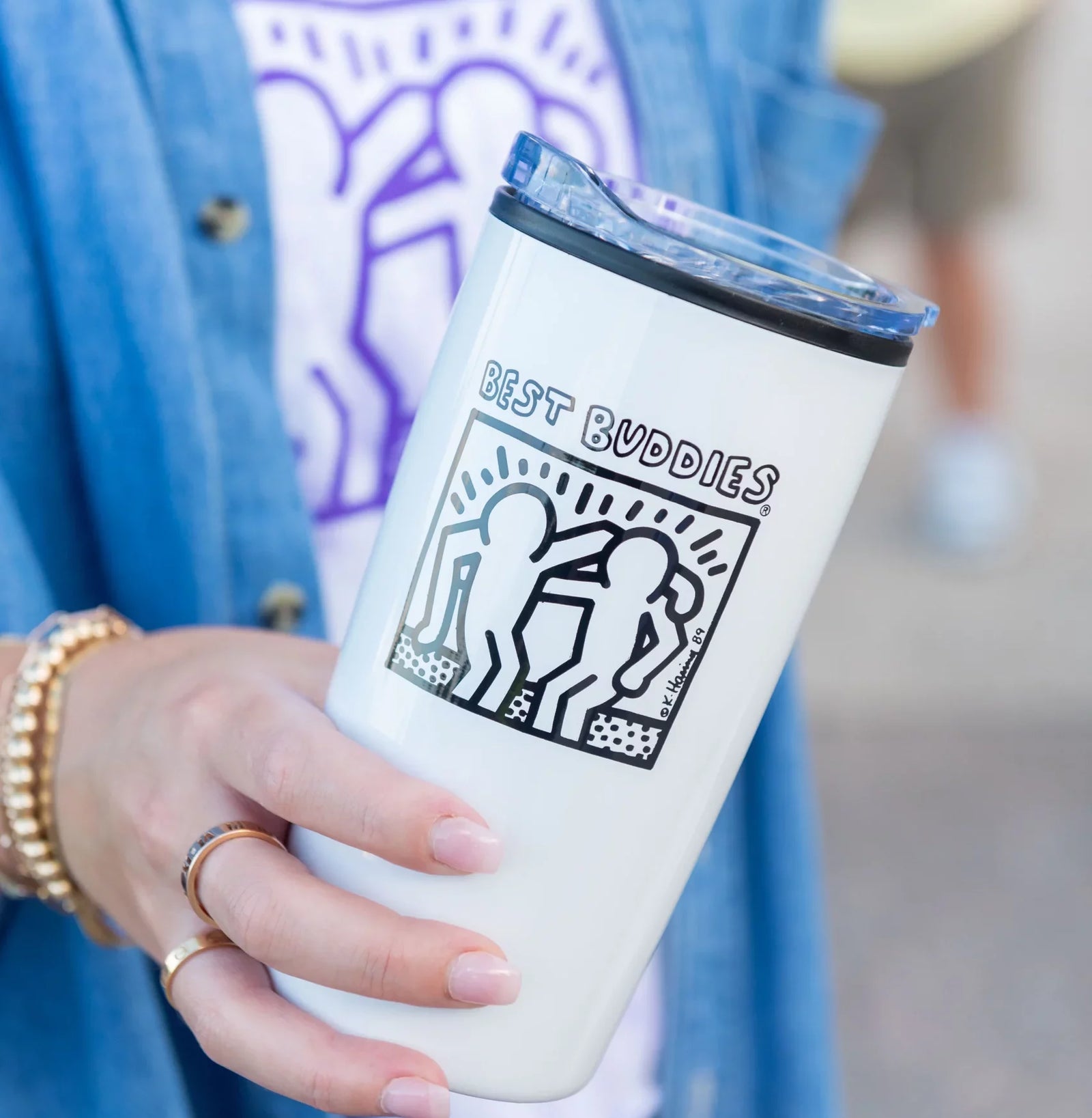 White tumbler with black haring Best Buddies logo