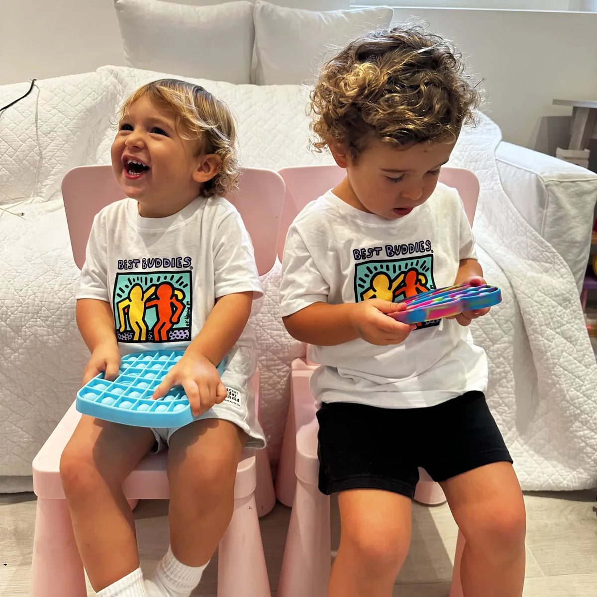 White toddler tee shirt with colorful traditional Haring Best Buddies Logo on the front