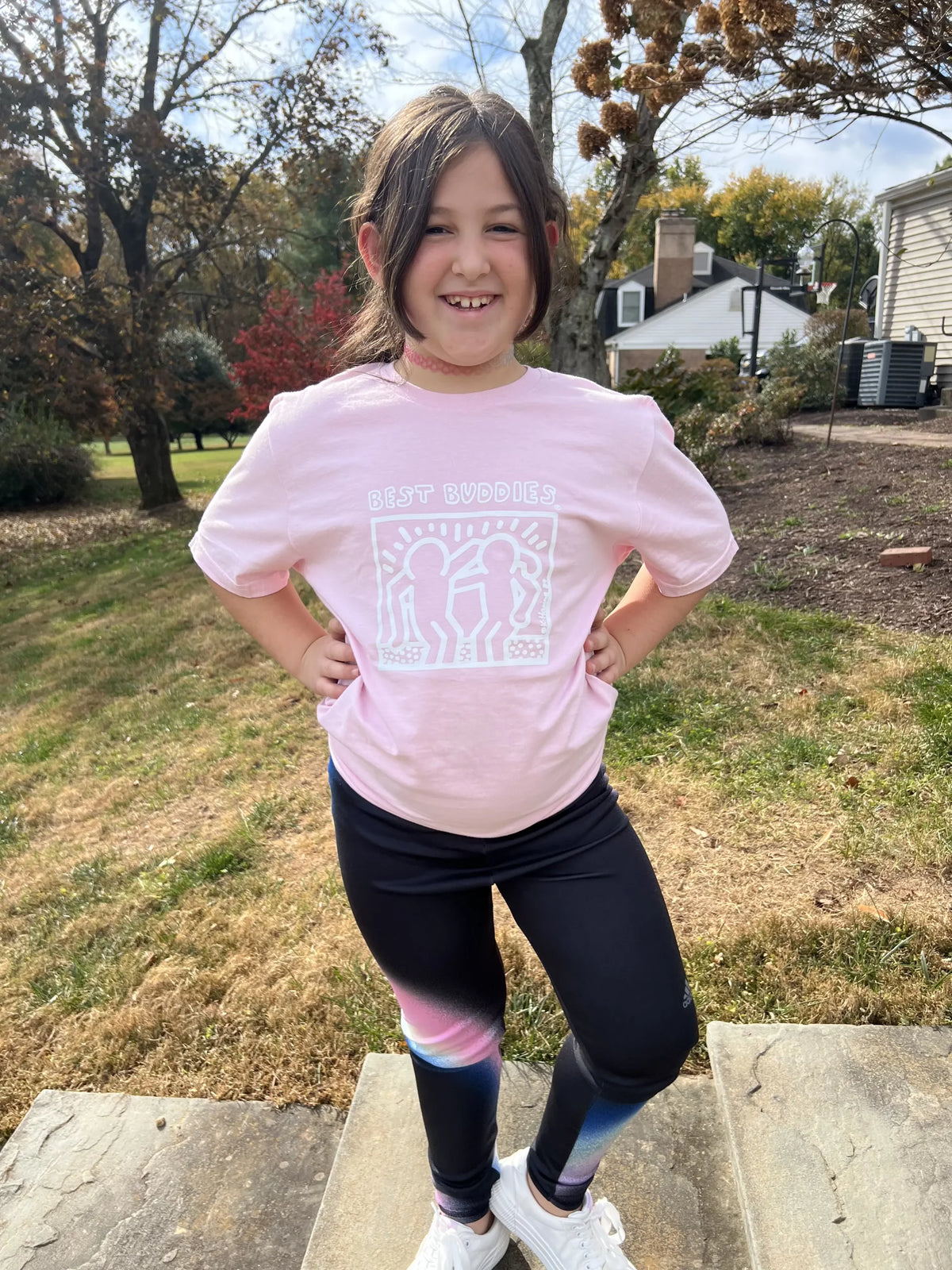 Pink youth shirt with White Haring Best Buddies Logo on the front