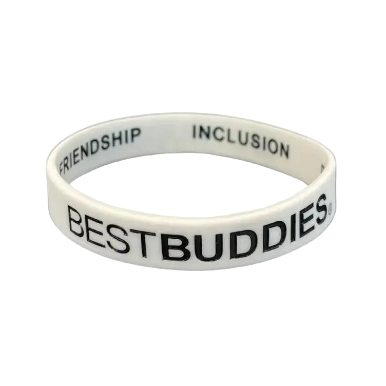 white bracelet with "best buddies" written on the outside, and "friendship, inclusion, respect, and acceptance" written on the inside
