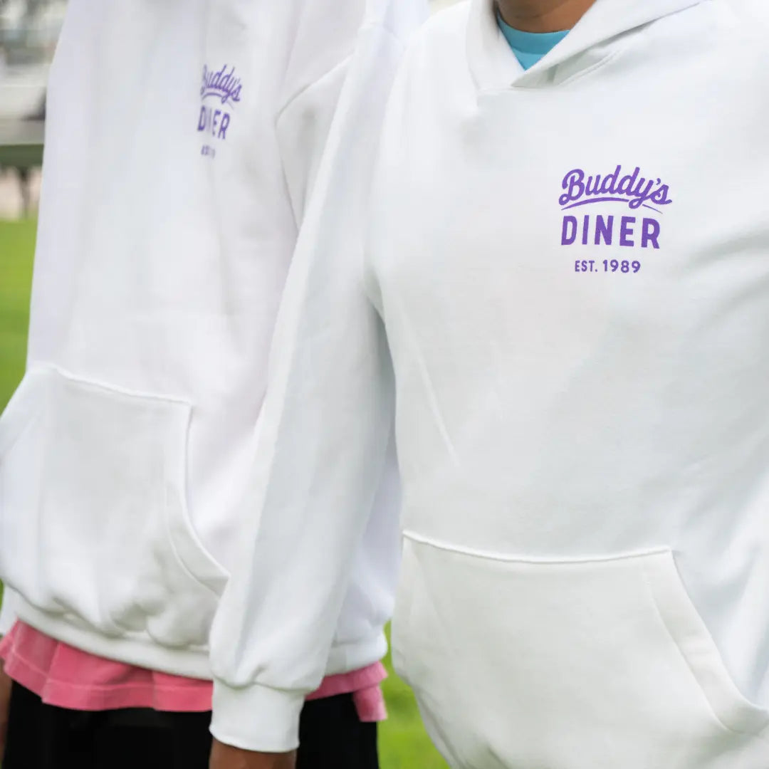 White Best Buddies Hoodie featuring a colorful ‘Buddy's Diner’ graphic with retro diner design on the back.