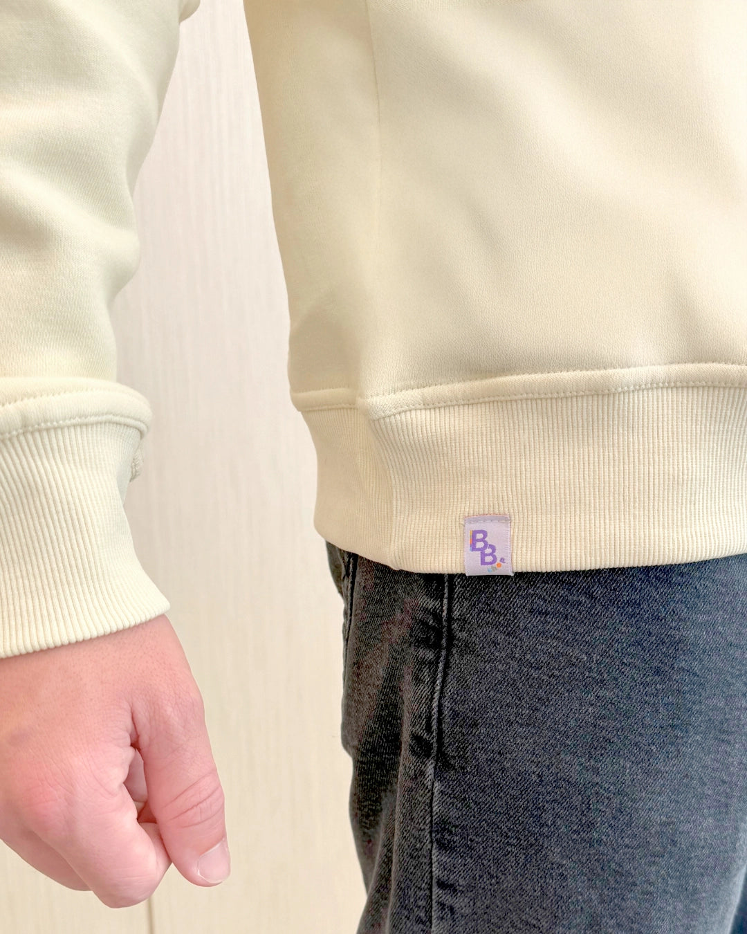 Cream Chenille sweatshirt with navy embroidered "Best Buddies" on the front