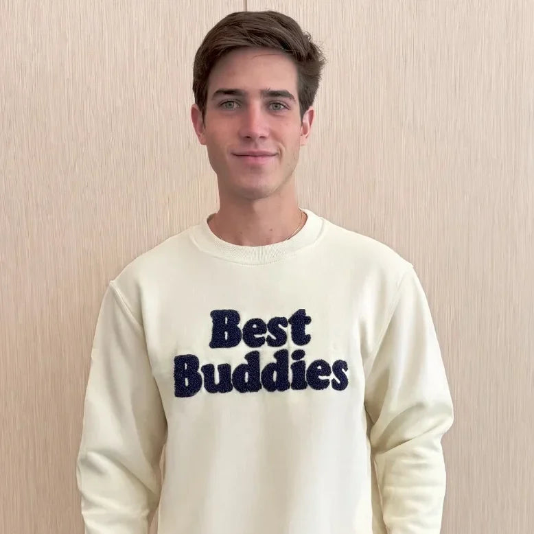 Cream Chenille sweatshirt with navy embroidered "Best Buddies" on the front