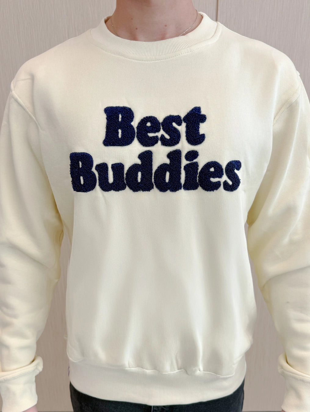 Cream Chenille sweatshirt with navy embroidered "Best Buddies" on the front
